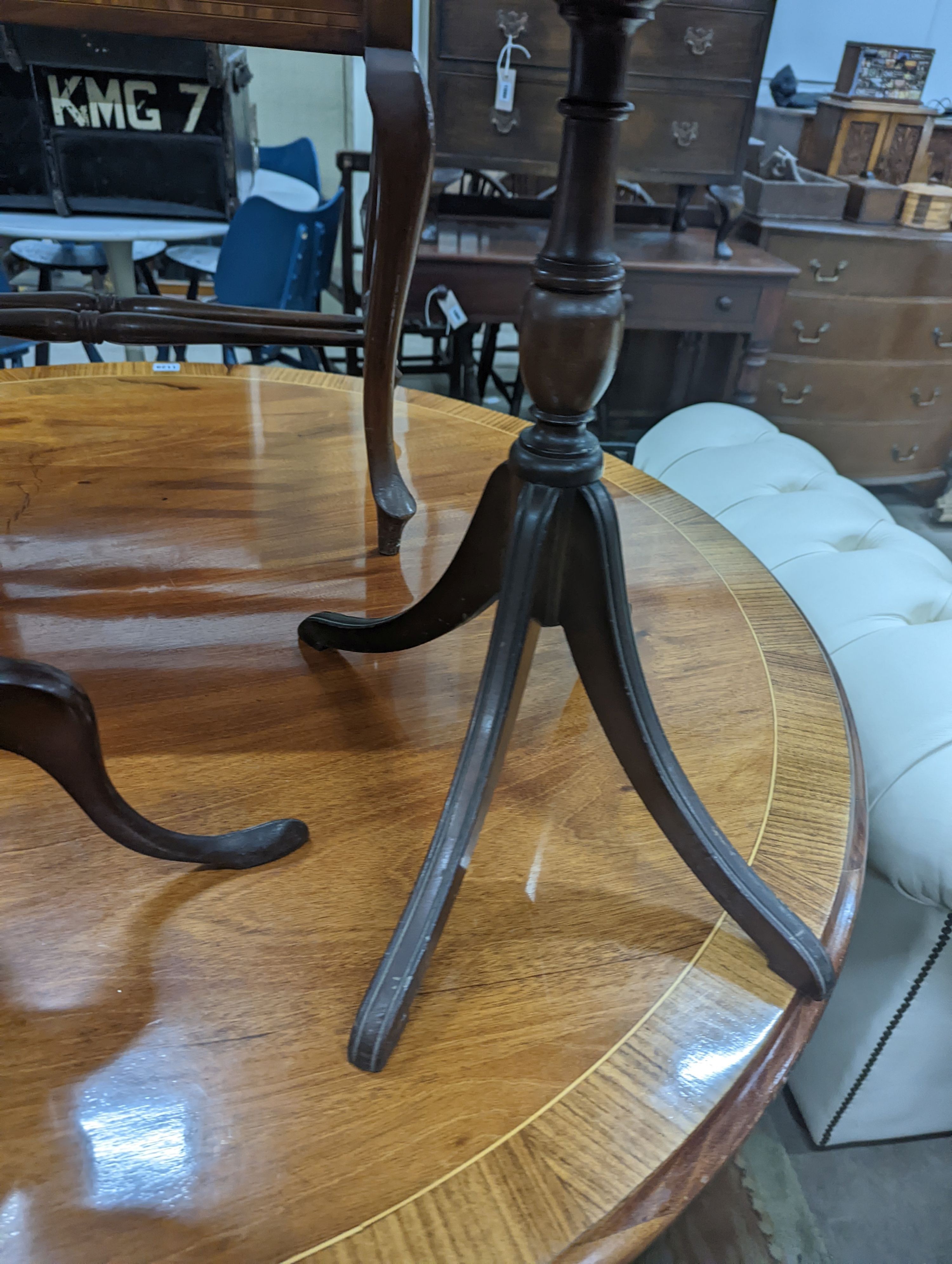 Two Edwardian inlaid mahogany tripod wine tables, larger height 50cm, together with a later folding oval wine table (3)